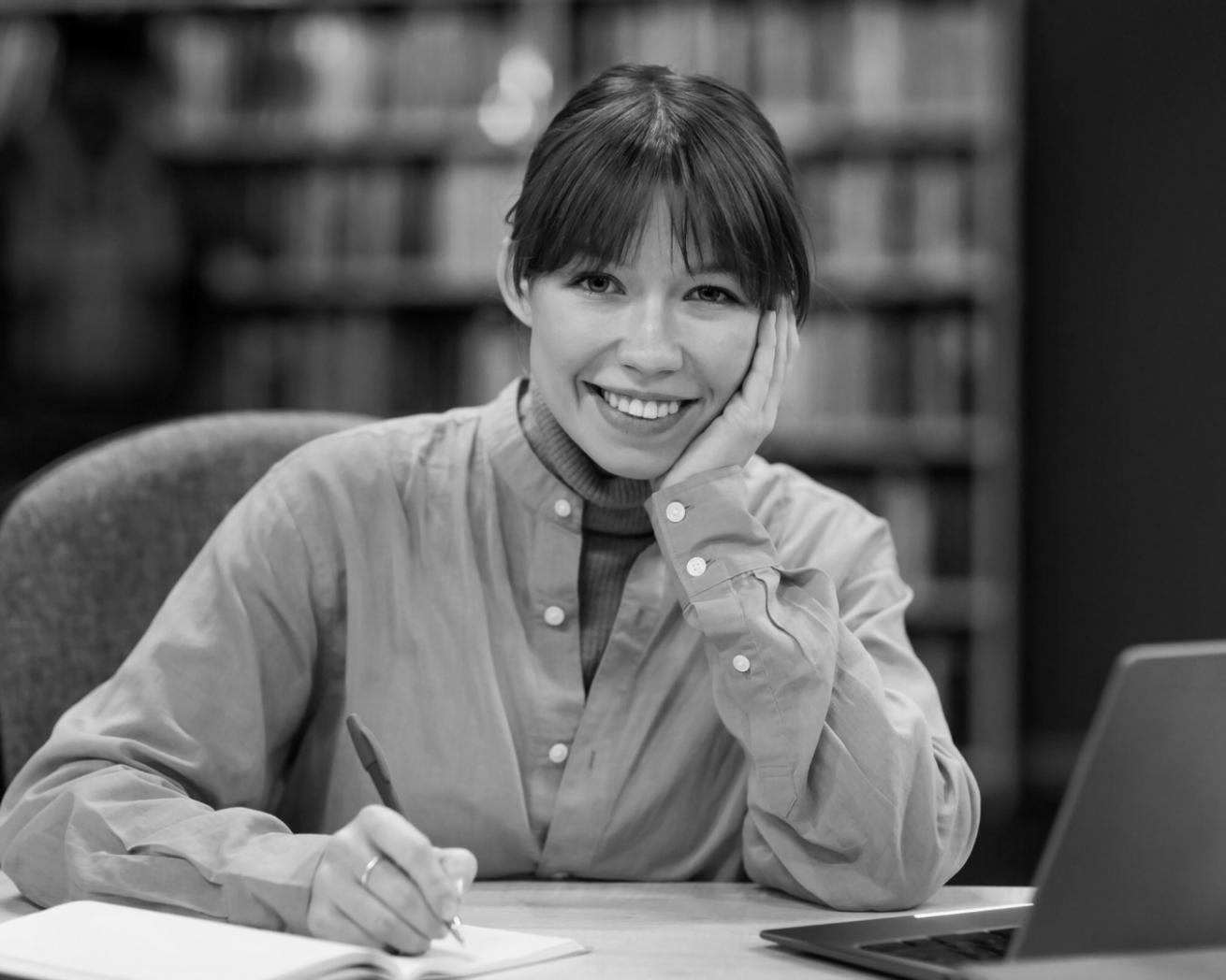 Professional workspace showing computer setup with financial spreadsheets and business planning materials